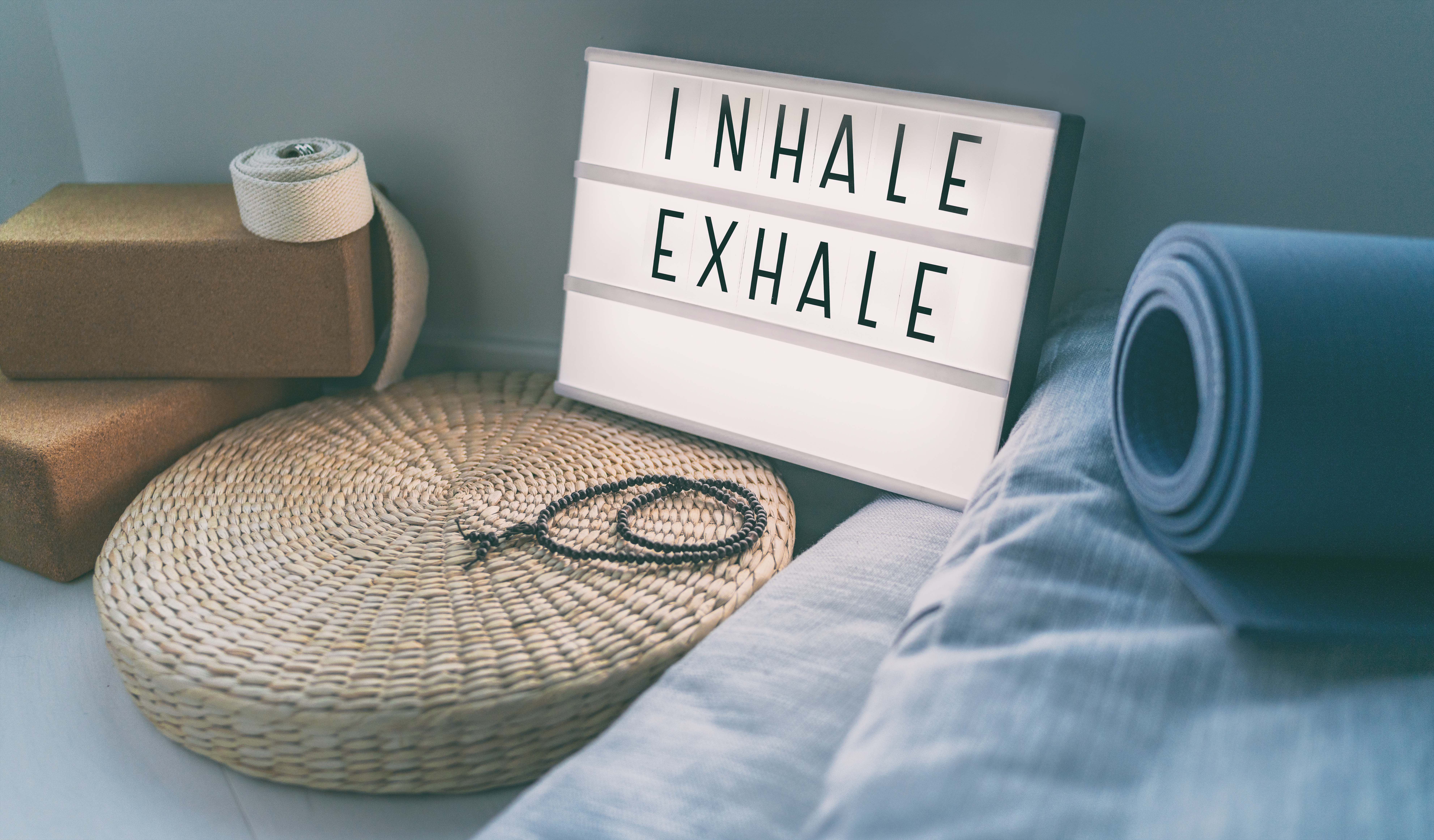 Light up sign that says Inhale, Exhale
