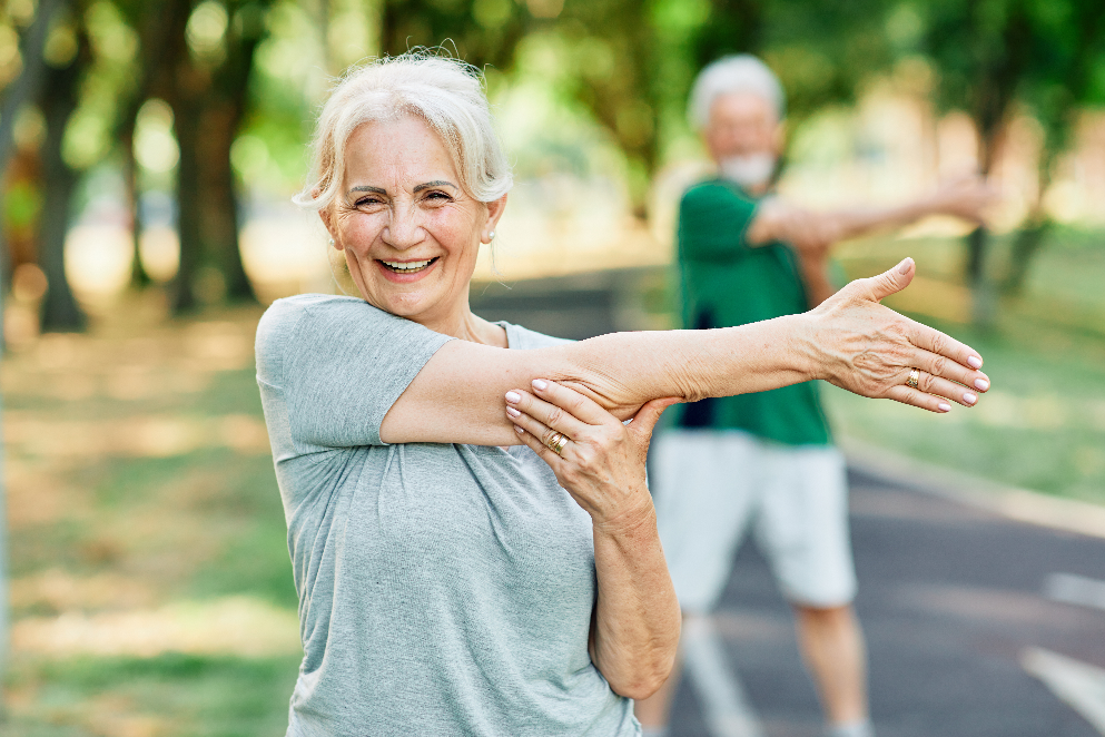 Elderly couple exercising in park