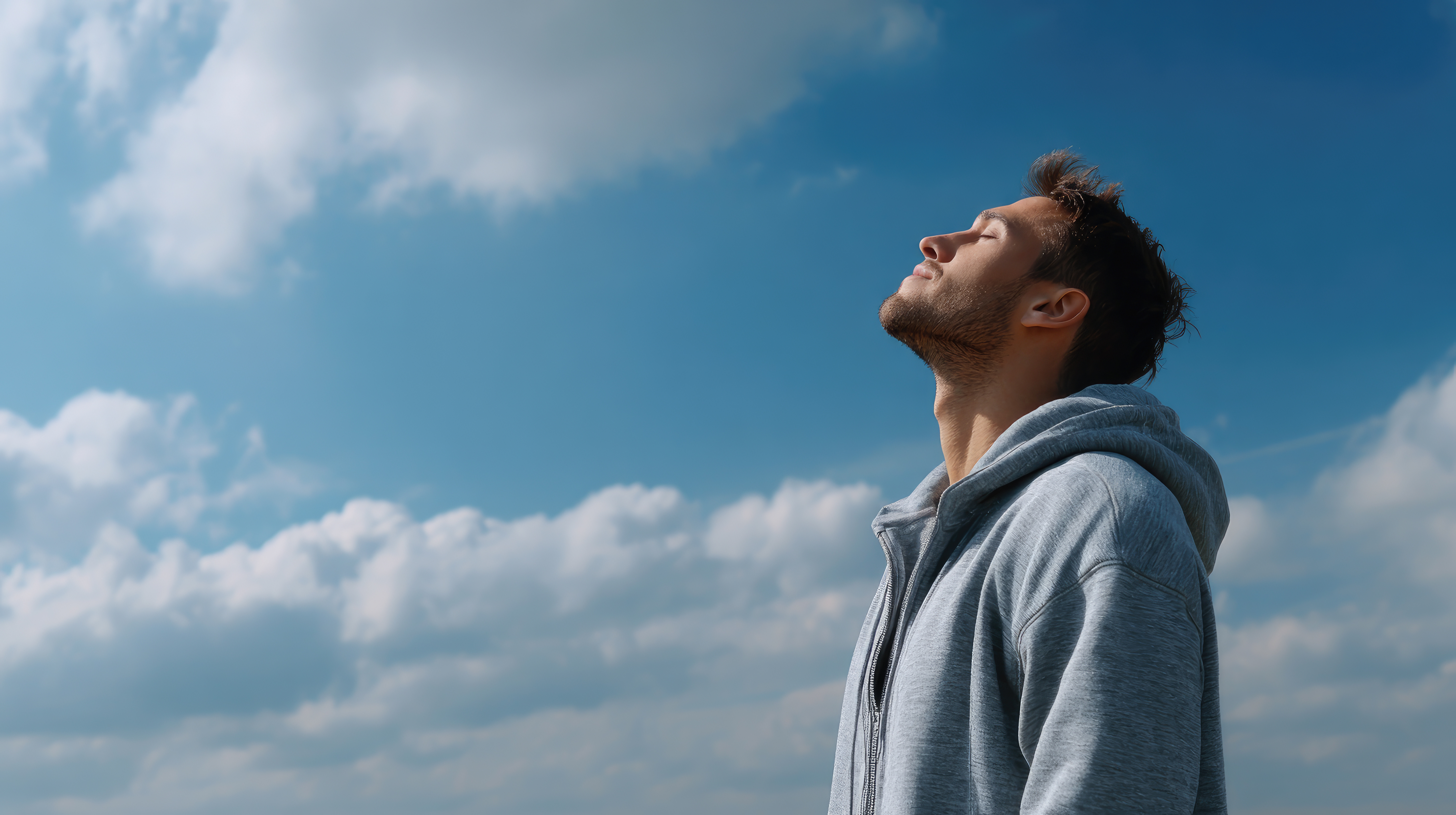 man relaxing outside in sunlight