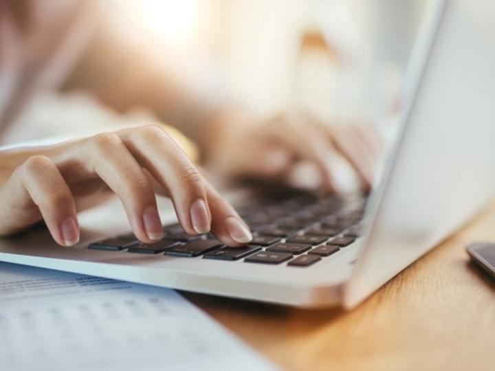 Closeup of hands at computer
