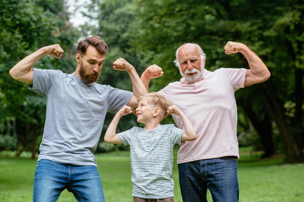 boy, dad, and granddad flexing muscles