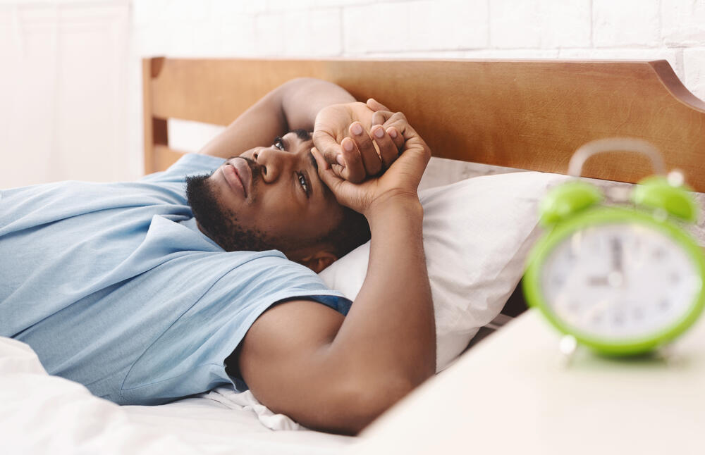 Man laying down in bed