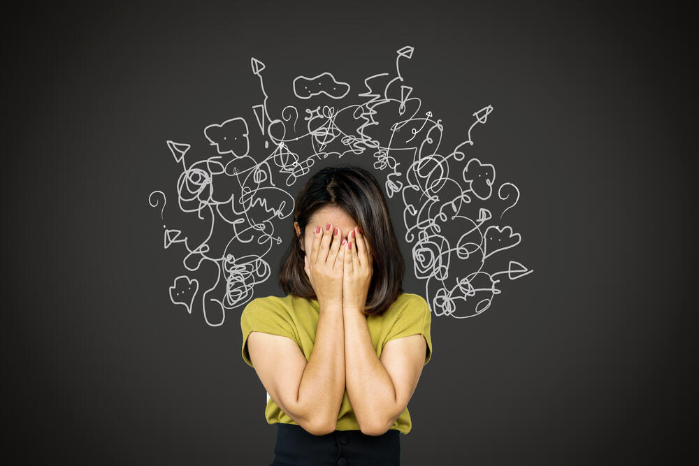 woman who is stressed with her head in her hands