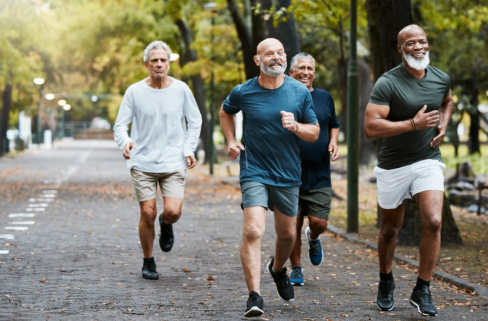 Group of middle-aged men running in park