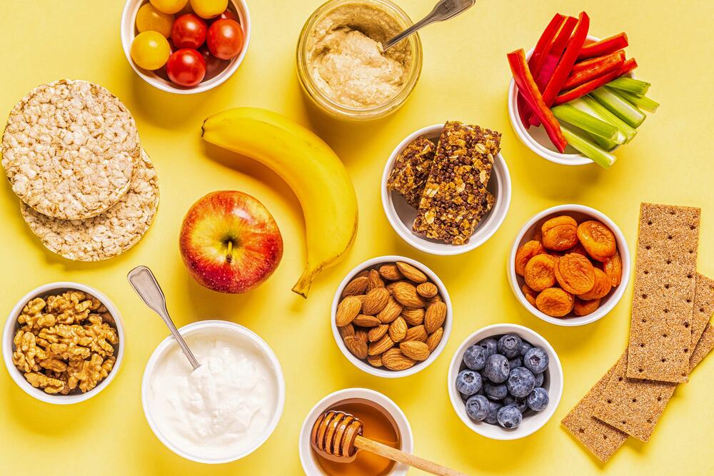 healthy snacks including yogurt, granola, fruits, veggies, and whole grains