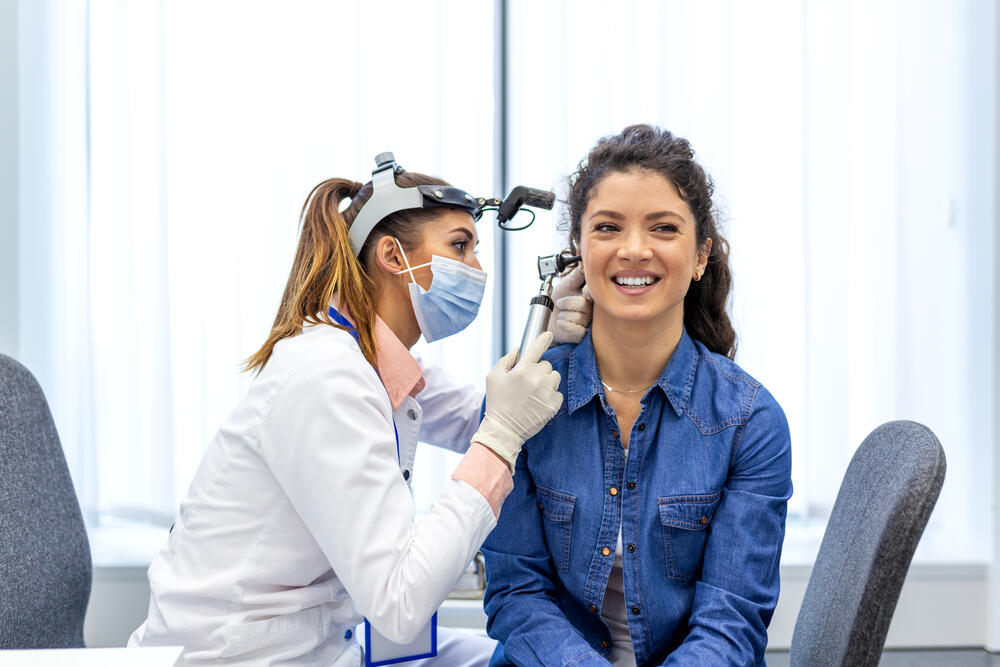 Woman getting ears checked by doctor