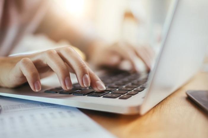 Closeup of hands at computer